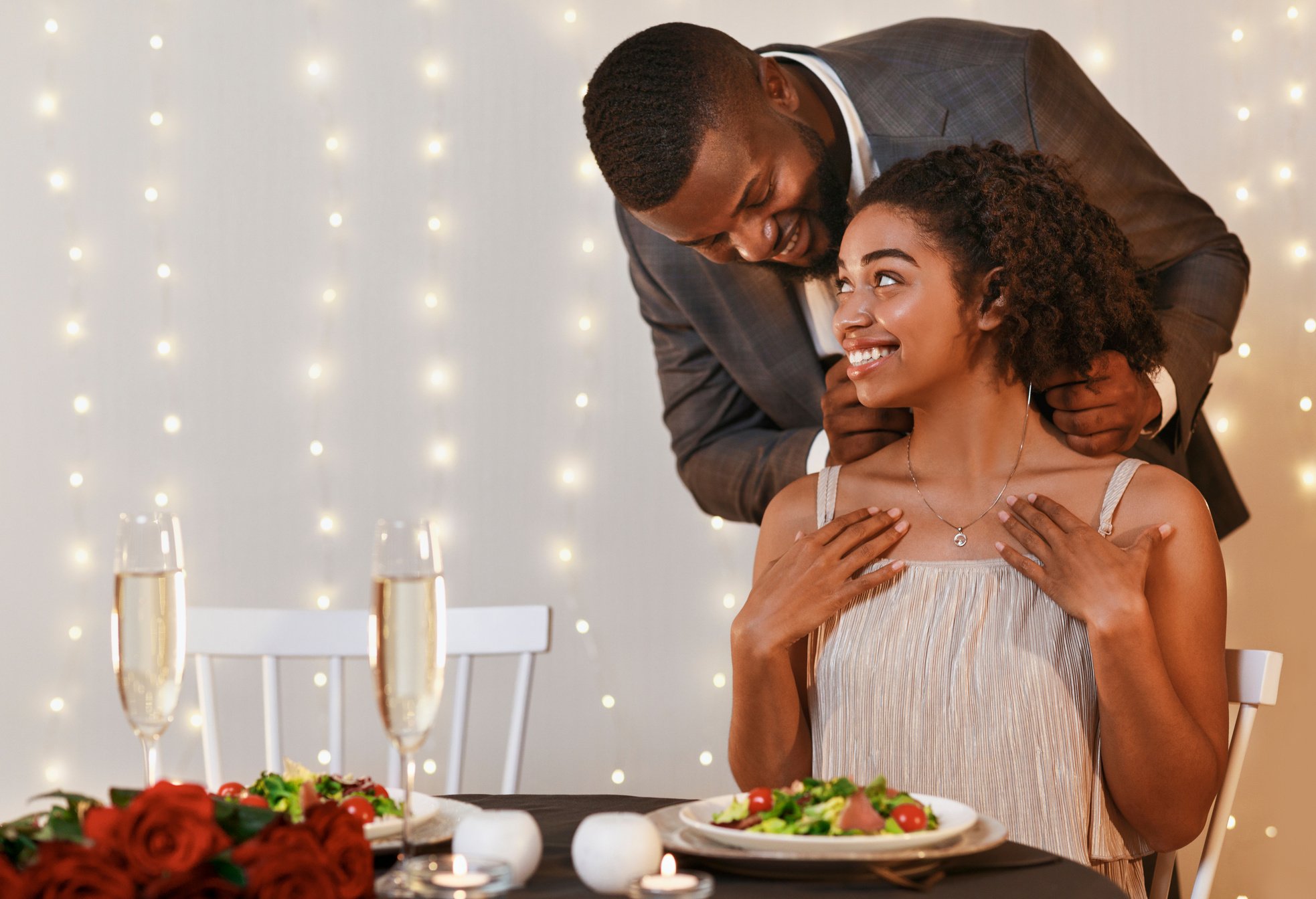 Loving black man giving woman elegant necklace